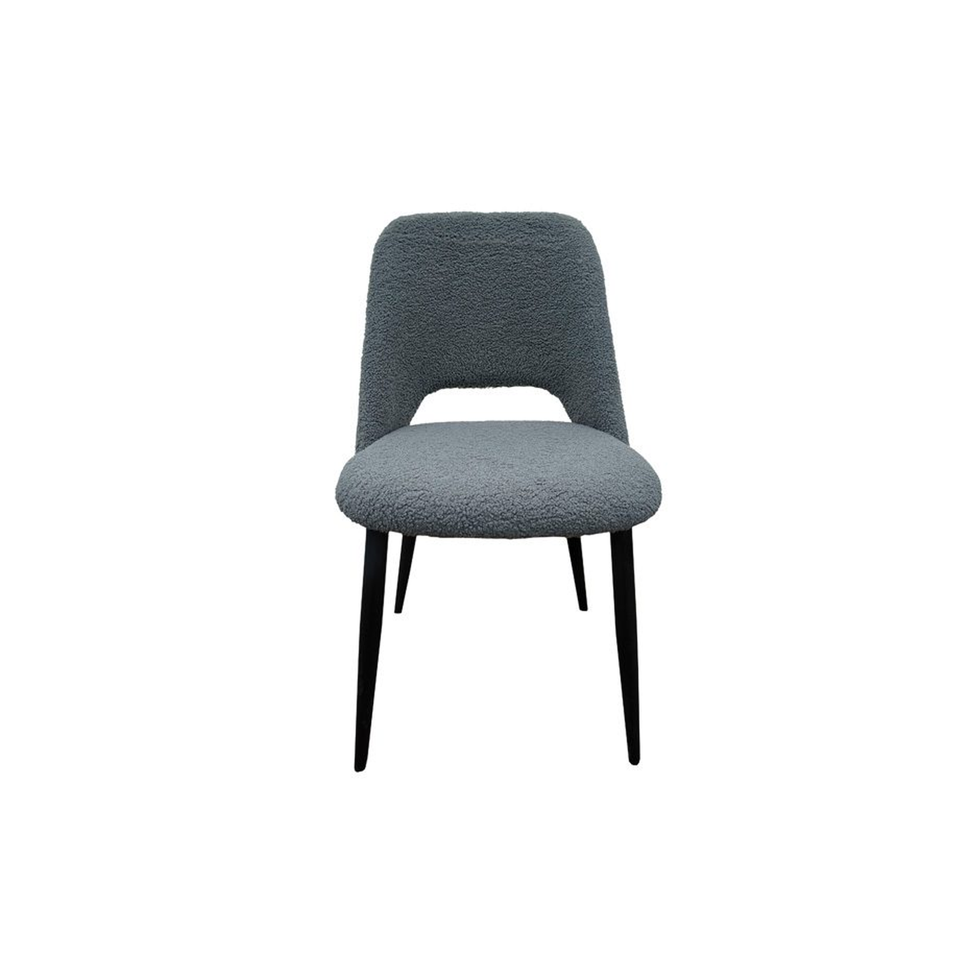 Silla de comedor tapizada en bouclé gris y patas metálicas en negro. Ideales para dar un toque elegante y glamouroso tanto en comedores como en cocinas.